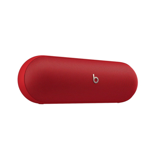 Beats Pill wireless Bluetooth speaker and portable charger in red with perforated grille and silver Beats logo, featuring up to 24 hours battery life, IP67 water resistance, Apple and Android compatibility, and suitable for use as a speakerphone.