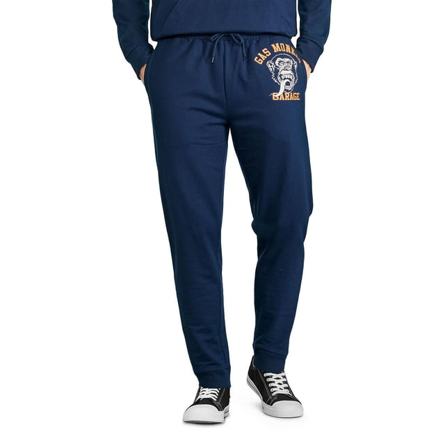 Gas Monkey Garage jogger pour Homme en Tricot Bleu Marine avec Taille Élastiquée et Cordon de Serrage, Poignets Côtelés, Deux Poches sur la Couture, et une Impression Graphique avant d'Un Visage de Singe et le Texte « Gas Monkey Garage » sur la Cuisse Gauche, Idéal pour une Tenue Décontractée Ou pour Se Détendre.
