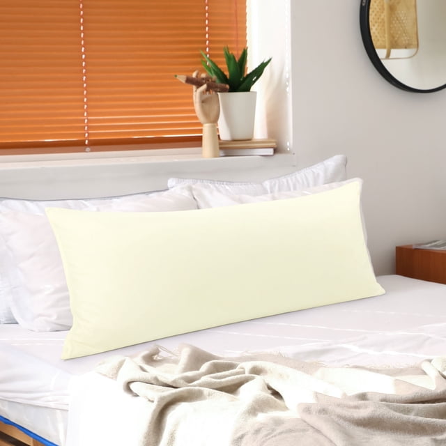 PiccoCasa Brushed Microfiber Pillowcase Body Pillow Pillowcase in standard pearl white, displayed on a neatly made bed. The pillowcase measures 20 x 48 inches and features a soft microfiber material with a zipper closure on the back for secure placement and easy removal. The setting includes a cozy bedroom with natural light, white bedding, and a beige throw blanket.