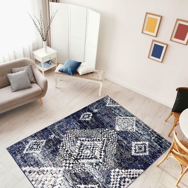 ECARPET Morrocan Area Rug Ultra Soft & Plush Mosaique Collection with navy blue and white geometric trellis patterns on light hardwood flooring, displayed in a bright living room with beige sofa, tufted bench, white side table, and colorful framed wall art, ideal for indoor high-traffic spaces.