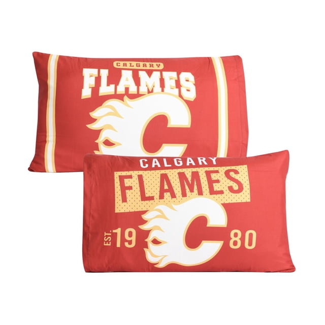 NHL Calgary Flames 2-Pack Pillowcases, 20" x 30", reversible red polyester microfiber pillow covers featuring the official Flames logo, bold team name, and establishment year 1980. Designed for standard pillows, ideal for adding team spirit and comfort to any hockey fan’s room.