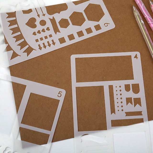 Plastic Planner Stencils Journal Notebook Diary Scrapbook DIY Drawing Template by Czzoypi, featuring 12 white PET stencils with various shapes and icons for scrapbooking and paper crafts. Includes templates for banners, hearts, hexagons, and arrows, suitable for pens, markers, and pencils. Compact size of 10x7.5cm, displayed on a brown background with pens nearby. Ideal for travel or compact storage.