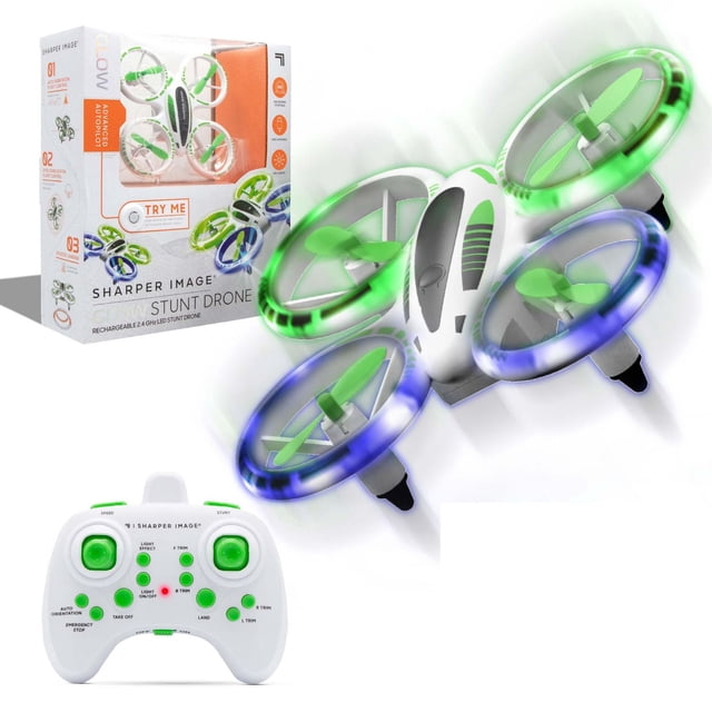 Sharper Image Drone Cascade Lueur DEL 5 Pouces Montrant un Quadricoptère Drone Blanc avec des Protecteurs d'Hélice à DEL Verts et Bleus en Vol, une Télécommande Blanche avec Commandes Vertes, et l'Emballage du Produit Mettant en Valeur un Pilote Automatique Avancé et une Pile au lithium rechargeable, Convient aux Utilisateurs de Drones Débutants.