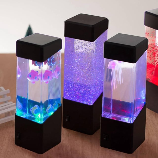 Round Jellyfish Lamp - USB Powered - Jellyfish Lava Lamp Mood Lamp with a rectangular acrylic tank containing two plastic jellyfish. The lamp features seven-color LED lighting and can be powered by 3 AA batteries or a USB cable. The black base and top provide a sleek design, making it ideal for mood lighting or as a decorative novelty piece.