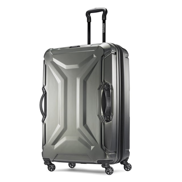 American Tourister Cargo Max Large Hardside Spinner suitcase in textured dark grey ABS with rugged split case design, four ball spinner wheels for smooth mobility, three cargo handles for easy lifting, and a push-button adjustable telescoping handle, shown at a 3/4 angle on white background, ideal for checked luggage travel.