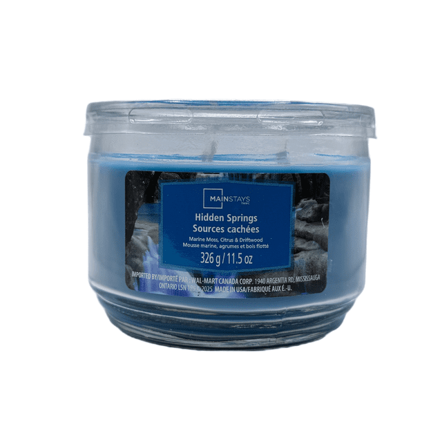 MAINSTAYS PL Hidden Springs Scented 3-Wick Glass Jar Candle, 11.5 oz, containing light blue wax in a clear round glass jar with a blue label describing its marine moss, citrus, and driftwood scent, suitable for home décor and enhancing relaxation.