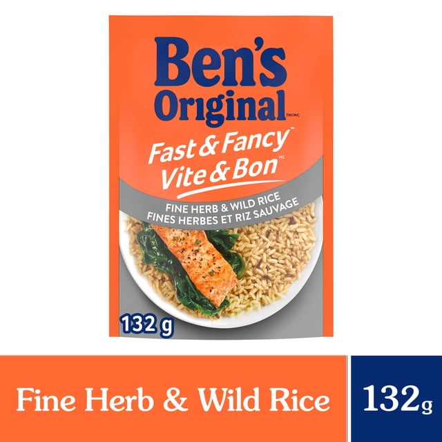 Ben's Original Fast & Fancy Fine Herb & Wild Rice 132 g pouch with orange and gray packaging showing a plate of cooked long grain and wild rice served with salmon and spinach, highlighting the herb-seasoned rice as a quick, easy-to-prepare side dish ideal for family meals.
