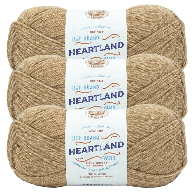 Lion Brand Yarn Heartland Yarn 3Pack featuring three skeins of worsted weight acrylic yarn in a heathered tan shade, each with a white label displaying the Lion Brand logo and Heartland branding, machine washable and ideal for knitting, crochet, and durable handmade crafts.