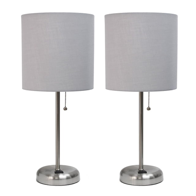 LimeLights Brushed Steel Stick Lamp with Charging Outlet and Fabric Shade 2 Pack Set with two table lamps featuring brushed steel round bases, slim stems, and cylindrical light grey fabric shades, each with a pull chain switch and built-in 2-prong charging outlet in the base, suitable for bedrooms, dorms, or offices.