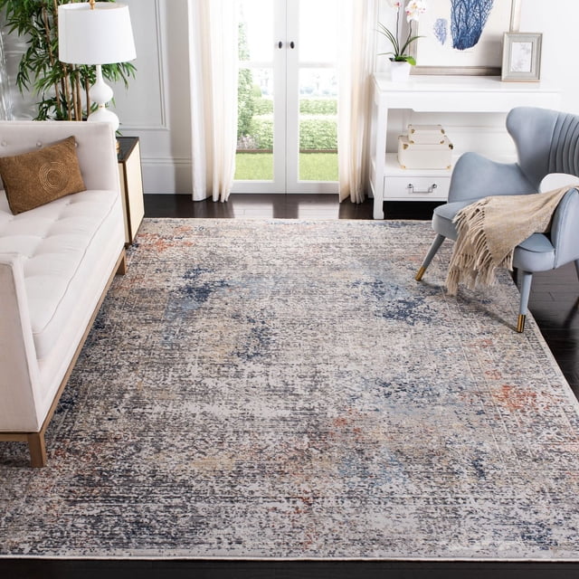 Safavieh Dream Jessamine Tapis Traditionnel Surteint avec un Motif Multicolore Usé en Tons Bleu, beige et Rouille, Tissé Mécaniquement à l'Aide de techniques de Nouage Persanes. Positionné sur un Plancher de Bois Franc Foncé dans un Salon Éclatant entre un sofa Crème et un Fauteuil Bleu Pâle avec un Jeté beige. le Tapis Ajoute une Touche Traditionnelle Mais chic de designer à la Déco de la Maison et Est Souvent Utilisé comme point focal Stylé dans les collections de Tapis d'Accent.