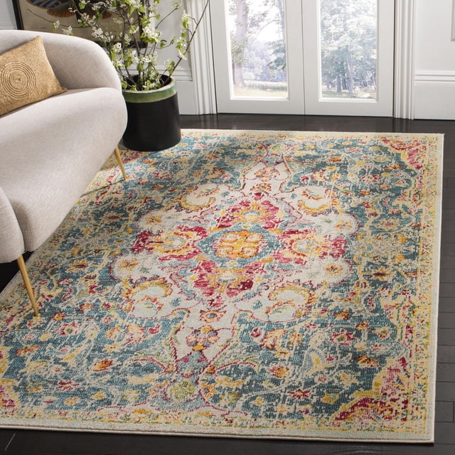 SAFAVIEH Phoenix Kieran Tapis Abstrait à Motif Floral avec Médaillon central Vieilli et Bordure Florale en Tons Bleu, Rouge, Jaune et Crème, Fait de Fils Synthétiques Doux avec Poil de Coupe Moyenne, Posé sur Plancher de Bois Franc Foncé à Côté d'Un sofa beige et d'Une Plante en Pot Verte Près de Portes en Verre, Idéal pour les Salons Ou les Salles à Manger.