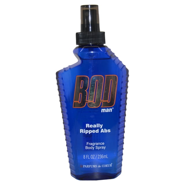 Bod Man Really Ripped Abs by Parfums De Coeur, an 8 oz fragrance body spray for men. The bottle features a bold blue design with a black spray nozzle and orange branding. This masculine scent includes notes of patchouli, bergamot, mandarine, peony, grapefruit, pepper, ylang-ylang, and musk, ideal for evening wear.