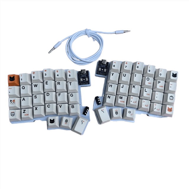 Silakka 54 Split Keyboard Wired Ergonomic Split Keyboard Key Changing Hot-swappable Two-hand Split Keyboard. This wired keyboard features a two-hand split design with customizable keys supported by QMK/VIAL software. It uses an RP2040zero development board as the main controller and includes a hot-swappable shaft holder with grey wood switches. The keyboard comes with a 3.5mm audio cable and has a unique keycap design with cat-themed icons.