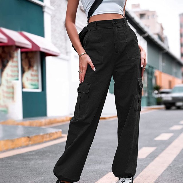 Meichang Women's Cargo Pants with 6 Pockets, high-waisted design, elastic waist, and solid black color. Made from lightweight and breathable fabric, these pants feature a straight wide-leg silhouette and multiple functional pockets, ideal for casual wear, summer outings, outdoor activities, or hiking. Styled with a cropped white top and sneakers in an urban street setting.