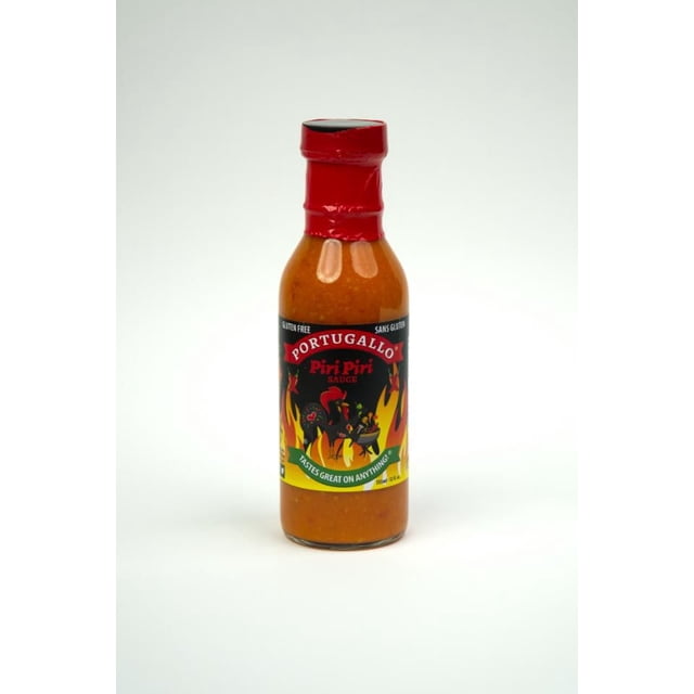 Portugallo Piri Piri Sauce in a 355ml clear glass bottle with red cap and black label featuring flames and chili peppers, a gluten-free spicy herbal hot sauce that adds a fresh kick to meals and is suitable as a versatile condiment.