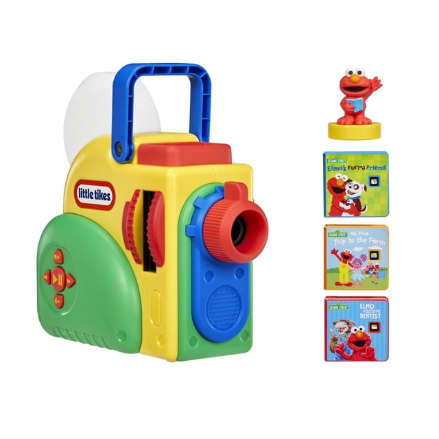 Little Tikes® Story Dream Machine™ Sesame Street® Special Edition – multicolour educational toy projector with yellow, green, blue, red, and white parts, featuring a blue handle, red lens, and side control buttons, accompanied by an Elmo figure and three Sesame Street story cartridges for interactive storytime and early reading development.