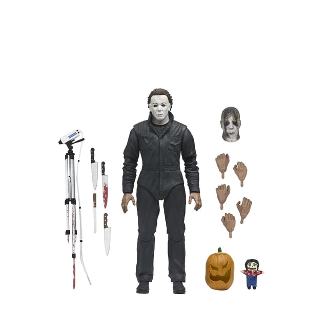 NECA Halloween: Resurrection - Ultimate Michael Myers 7" Scale Action Figure — 7-inch scale articulated Michael Myers figure from Halloween: Resurrection, centered front-facing in collector window-box with opening flap; includes interchangeable hands, burned mask head, kitchen knife, serrated and broken knives, tripod camera and doll. Suitable for shelf display, dioramas or horror figure photography.
