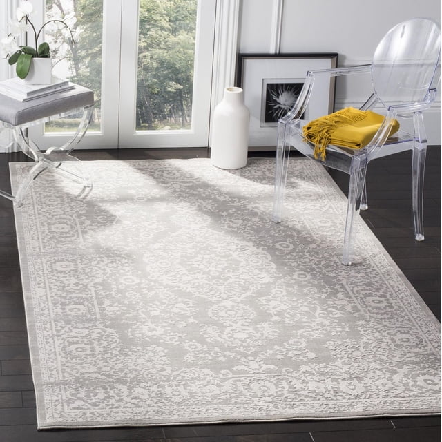 SAFAVIEH Princeton Tapis à Bordure Florale Weldon avec Motifs Floraux vintage et texture Subtile en Relief dans un Ton Neutre Doux, Posé sur un Plancher de Bois Franc Foncé dans une Pièce Lumineuse avec une Chaise en Acrylique Transparent Tenant un Jeté Jaune et une table d'Appoint avec des Orchidées Blanches, Convient pour Rehausser la Déco Maison Traditionnelle Ou Moderne.