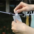 thumbnail image 4 of TACILIP Organisateurs et Rangement de Garde-Robe, Corde à Linge Coupe-Vent Rétractable avec Boucle Fixe, Corde à Linge de Voyage Pratique avec Pinces 12 Pinces à Linge 70,87 Po, Cadeaux de Pendaison de Crémaillère, 4 of 6