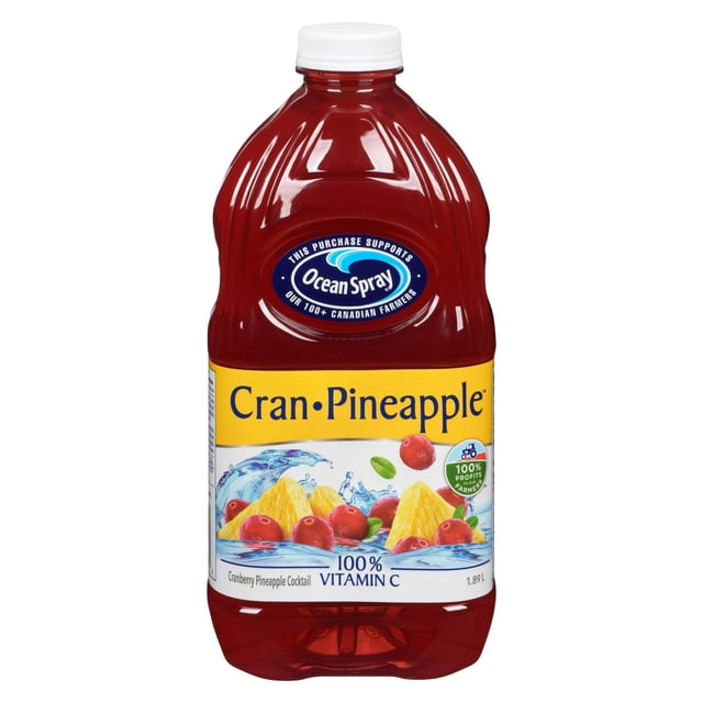 Ocean Spray Cran•Pineapple™ Cranberry Pineapple Cocktail 1.89L plastic bottle with red juice, white cap, and yellow label featuring cranberries and pineapple chunks in water splash, highlighting 100% vitamin C and support for Canadian farmers, often enjoyed with sparkling water or spirits.