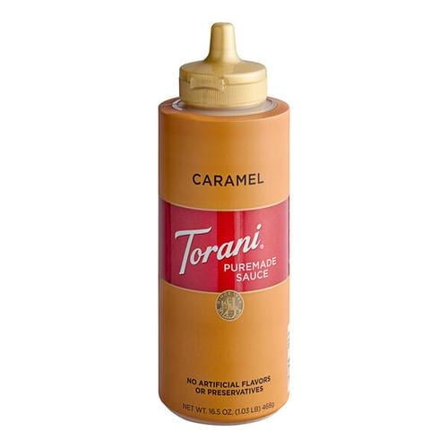 Torani Puremade Caramel Sauce, Premium Buttery Dessert & Coffee Topping, 12 fl oz (355 mL) squeeze bottle with a golden caramel-colored body and red label featuring the Torani logo. The clean-label sauce is free of artificial flavors and preservatives, with a precision nozzle for mess-free drizzling. Ideal for coffee drinks, desserts, and premium culinary applications.