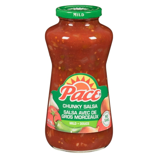 Pace® Mild Chunky Salsa, Shelf Stable, in a clear glass jar showing red salsa with visible chunks of handpicked jalapeños, onions, and tomatoes, featuring a green lid labeled 'Mild' and a green label with the Pace logo and no sugar added claim, suitable for dipping or cooking.