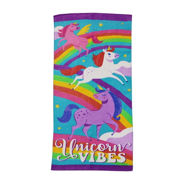 Mainstays Printed Beach Towel made of soft 100% cotton, measuring 28 by 60 inches, with a colorful print of three unicorns in pink, white, and purple on a blue background with rainbows and stars, featuring the phrase 'Unicorn Vibes' at the bottom, suitable for beach use or as a fun picnic blanket.