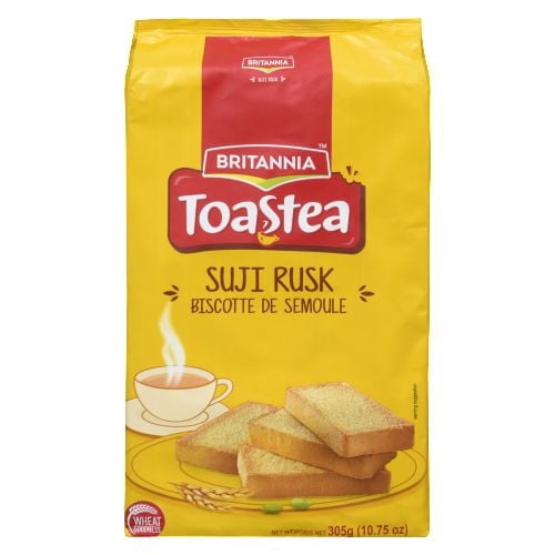 Britannia Sooji Toast Suji Rusk in yellow packaging with red Britannia logo, showing wheat rusks on a plate and steaming cup of tea illustration, 305g (10.75 oz) wheat-based Indian snack ideal for pairing with chai or as a light crisp snack.