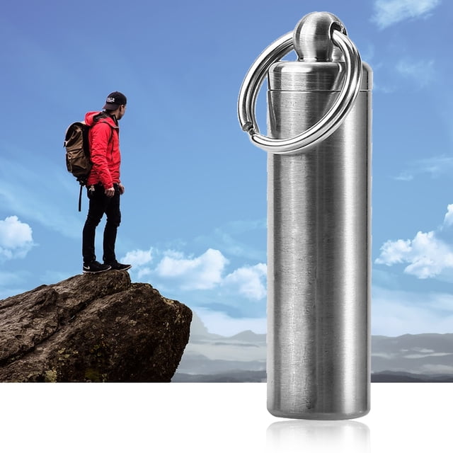 Garosa Stainless Steel Medicine Keychain Holder for traveling, camping, and emergencies. The compact silver pill holder is made of durable, anti-corrosive stainless steel with a polished finish. It features a waterproof seal ring to protect contents and an attached ring for easy attachment to a keychain. Dimensions: 15mm diameter, 56.5mm length (excluding ring).