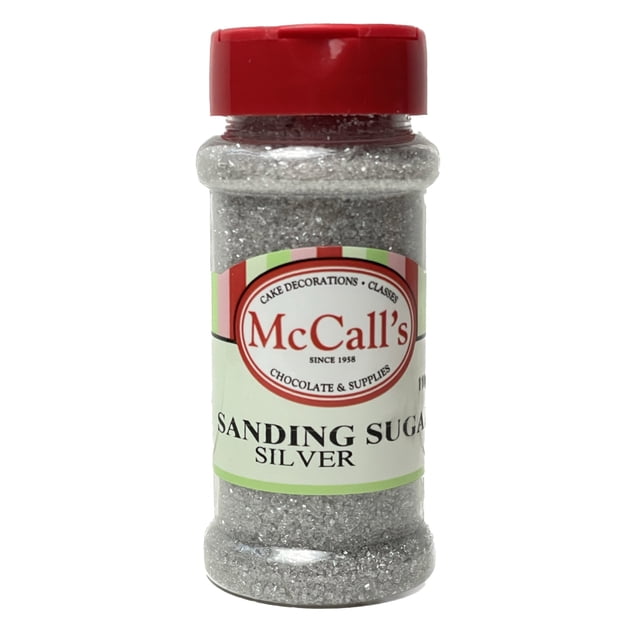 SUGAR SANDING SATIN SILVER 100 G by McCall's Bakers Warehouse, a 100 g container of silver sanding sugar. The bottle features a red cap and a label with McCall's branding, ideal for decorating baked goods like cookies, muffins, and candies. This decorative sugar holds its shape under heat and adds a crunchy texture.