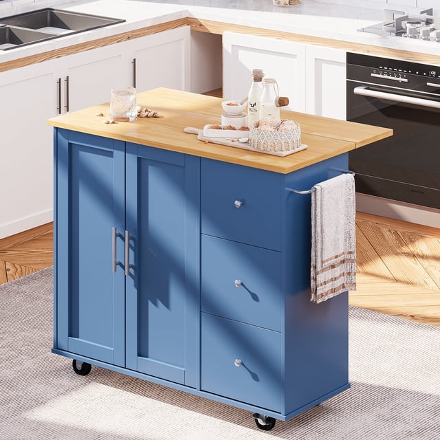 Walsunny Kitchen Island on Wheels with Storage Cabinet & 3 Drawer, featuring a 39.7-inch width and a blue finish. This rolling kitchen table includes a folding drop leaf for extra dining space, a large cabinet with two doors, three drawers, and a 3-level adjustable shelf for customizable storage. The sturdy wood construction has a water-resistant tabletop, and the cart is equipped with five smooth-rolling wheels, including two with brakes, for easy mobility and stable positioning. A side handle doubles as a towel rack, making it a versatile addition to any kitchen.