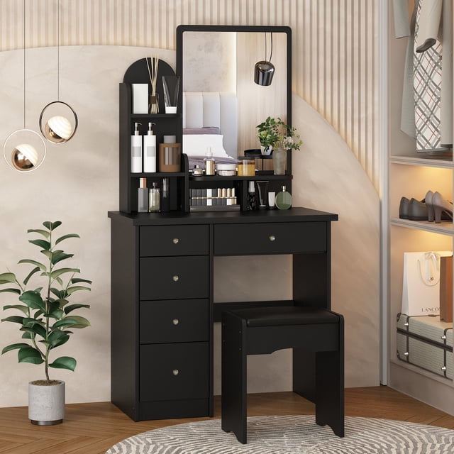 Oxylife Vanity Set with 5 Drawers and Chair, Makeup Dressing Table with Sliding Mirror in black. This modern bedroom vanity set features a spacious tabletop, five drawers, and three shelves for organized storage of cosmetics, jewelry, and beauty supplies. Made of environmentally-friendly MDF, the sturdy design ensures stability. The sliding mirror enhances functionality, while the matching stool completes the set. Perfect for bedroom use, shown in a contemporary interior with decorative accents and organized storage.