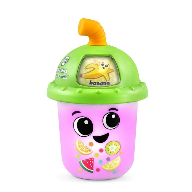 LeapFrog Fruit Colors Learning Smoothie™ educational toy cup with green lid and orange teether straw, featuring a banana character on a display window. The pink translucent cup base shows fruit illustrations like watermelon and lemon, designed for toddlers to explore colors and fruits with interactive sounds and color changes.