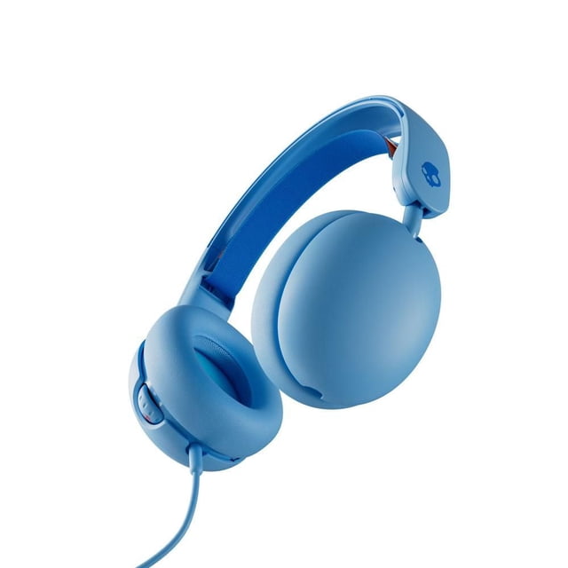 Skullcandy Grom Over-Ear Sound Isolating Kids Headphones in surf blue, shown at a 3/4 angle with padded over-ear cushions, adjustable fabric-lined headband, volume control buttons on the earcup, and wired connection, designed for kids 6+ with volume limited to 85 decibels, featuring a collapsible design and share audio port ideal for travel.