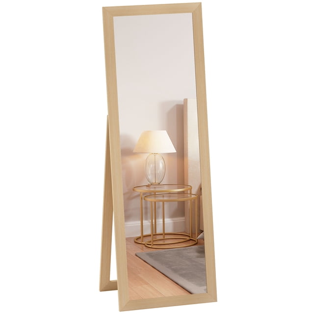 HOMCOM 58"x 20" full length mirror with a floor-standing design, featuring a sturdy MDF frame in an oak finish. The mirror measures 16.1 inches wide by 55.1 inches high, providing a full-sized reflection. Positioned in a cozy bedroom setting with a lamp and side table visible in the background.