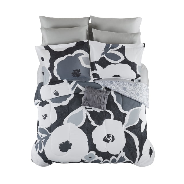 Mainstays 11 Piece Bed in a Bag featuring a black and white floral print comforter set with two pillow shams, four pillowcases, flat and fitted sheets, bed skirt, and a grey decorative cushion, made with 45% recycled polyester and OEKO-TEX certified, machine washable for easy care.