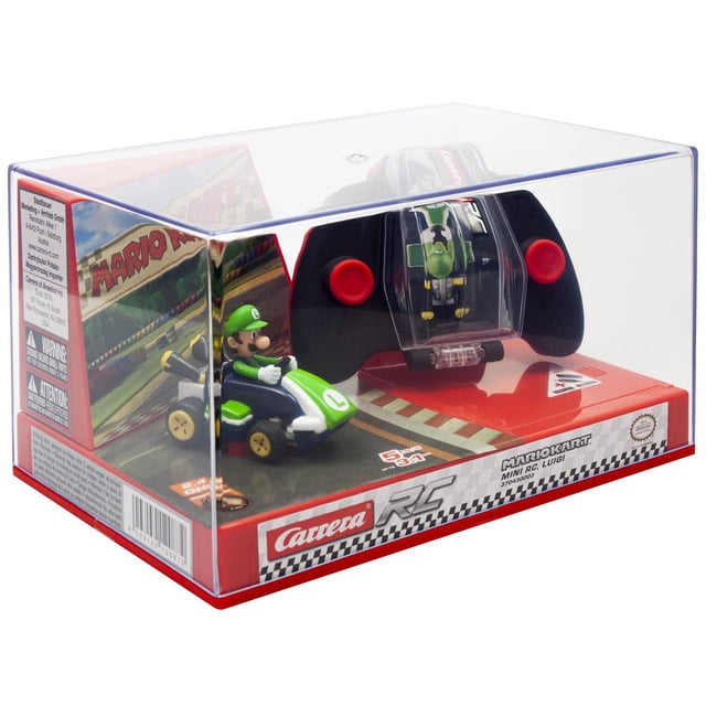 Nintendo Carrera RC - 2,4GHz Mario Kart(TM) Mini RC, Luigi with a 1:50 scale green and white Luigi mini remote control kart inside a clear plastic display box, including a black remote control with red buttons and a compartment to hold the kart, set on a red base featuring Mario Kart and Carrera RC branding.