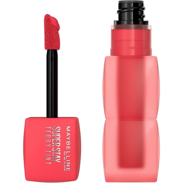 Teddy Tint, Soft Lip Gloss by Maybelline New York showing a close-up of the red square applicator wand with a plush angled tip and the frosted red bottle with a black pump dispenser, designed for up to 12 hours of long-lasting matte lip tint with a lightweight, no-transfer finish.