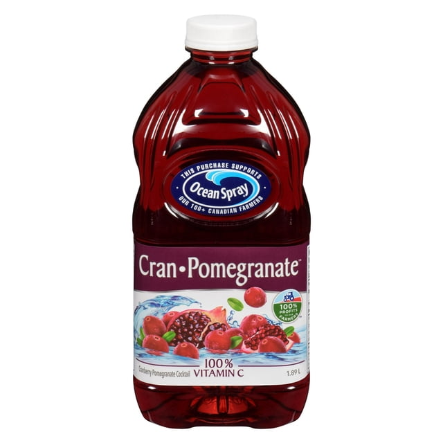 Ocean Spray Cran·Pomegranate™ Cranberry Pomegranate Cocktail in a 1.89 L red plastic bottle with a white cap, featuring a label with cranberries and pomegranate seeds in water, providing 100% vitamin C and supporting Canadian farmers, often enjoyed mixed with sparkling water or spirits.
