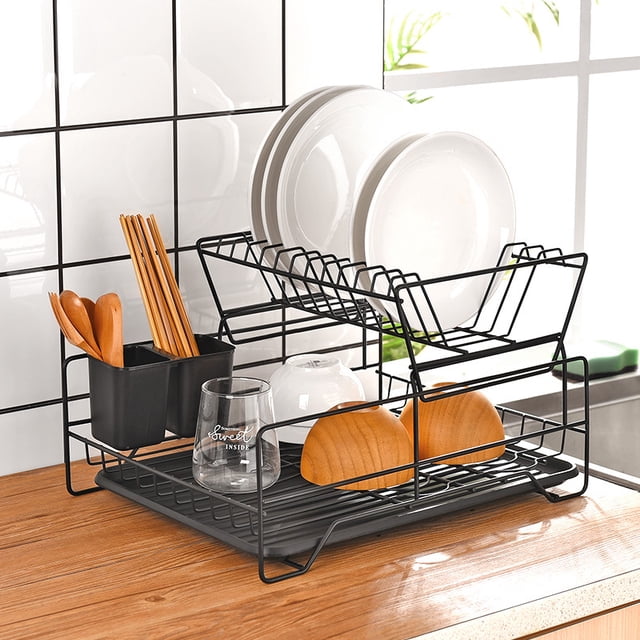 Dish Drying Rack, Dish Rack for Kitchen Counter, Rust-Proof Dish Drainer with Drying Board and Utensil Holder for Kitchen Counter Cabinet, 16.9” L× 12.9”W× 10.2”H, Black. The rack features a two-tier design with a steel wire frame, a removable utensil holder, and a bottom tray with a 360-degree rotating telescopic drain pipe for efficient water drainage. The setup includes space for plates, bowls, and cups, with a detachable structure for easy cleaning and installation. Shown on a wooden kitchen counter with a tiled backsplash.