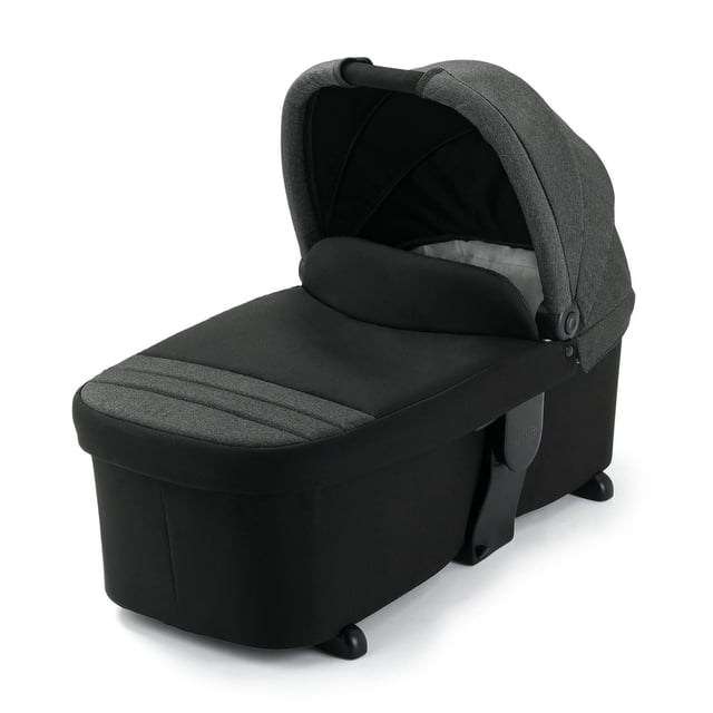 Graco Modes Carry Cot stroller bassinet in black and dark grey fabric with padded mattress and large canopy for sun protection, reversible to face parent or world, with integrated carry handle, compatible with most Modes strollers or carry cot stand.