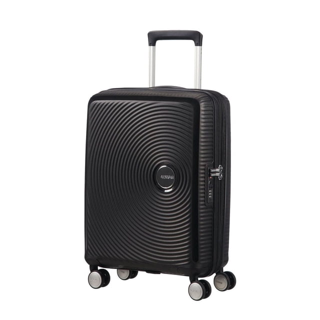 American Tourister Curio Spinner Carry-On in black with a concentric circle textured polypropylene shell, four dual spinner wheels for balanced rolling, a multi-stage telescoping handle, and an integrated TSA-approved lock, ideal for carry-on travel and organized packing.