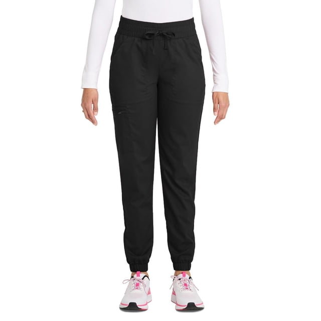 Scrubstar Pantalon de Sarrau Cargo Jogger à Cordon pour Femmes Ultimate Stretch WC047A en Noir, Vue de devant d'Un Modèle Portant un Haut à Manches Longues Blanc et des Espadrilles Blanc-Rose, avec Tissu Extensible, Jambes Fuselées, Taille à Cordon Ajustable, Cinq Poches Spacieuses Dont une Poche Cargo Zippée, et Poignets Élastiques pour un Confort et une Mobilité Toute la Journée.