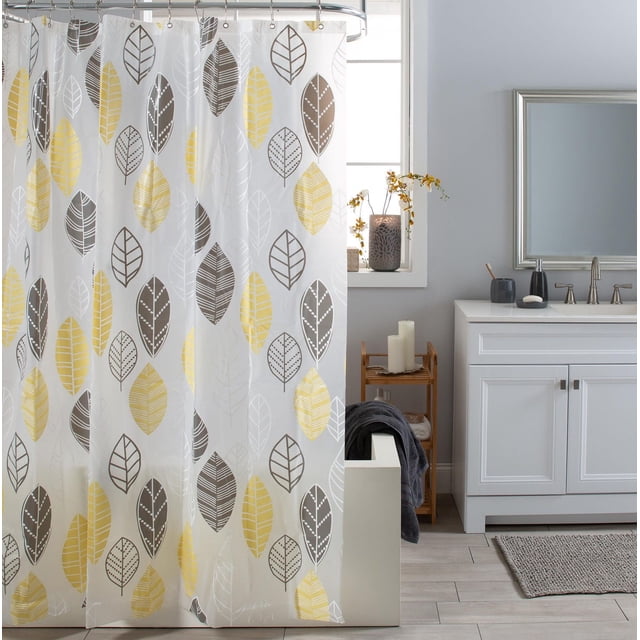 KATSURA PEVA shower curtain with grey and yellow leaf print on frosted white PEVA material, featuring rust-resistant grommets on a curved shower rod in a bathroom with white vanity, silver faucet, and decorative candles by a window, ideal for eco-friendly bathroom settings.