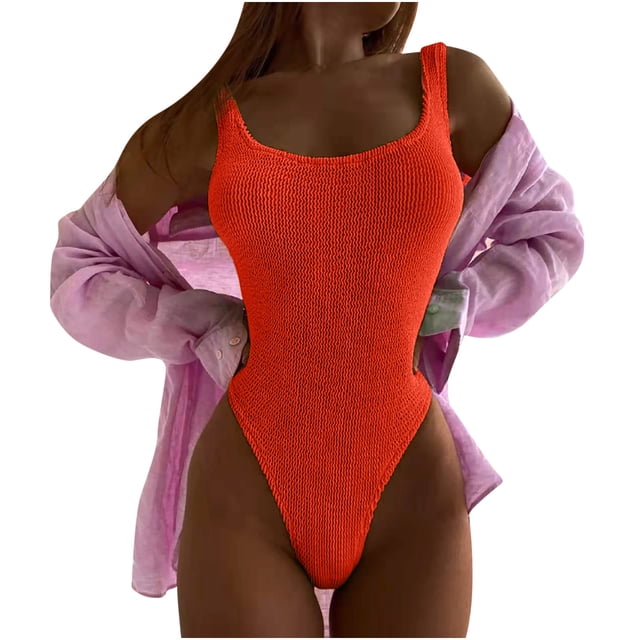 Women's Wrinkled Cloth Wave Fluorescent Color Fashion One-piece Swimsuit in a bright orange shade with a textured wrinkled fabric. This one-piece swimsuit features a scoop neckline and high-cut leg openings, designed for a flattering and stylish look. Made from soft polyester, it is ideal for summer activities like swimming, beach outings, or poolside lounging. The model pairs it with a sheer purple cover-up, emphasizing the swimsuit's vibrant color.
