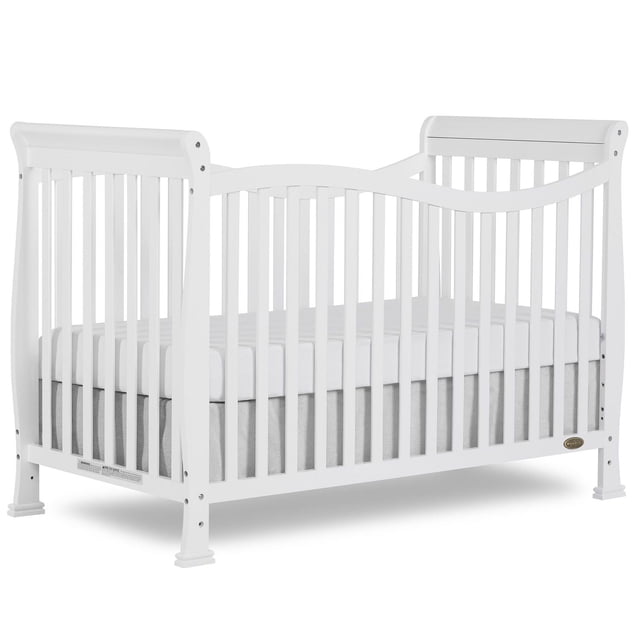 Dream On Me Violet 7-in-1 Convertible LifeStyle Crib in white finish, front 3/4 view showing curved top rails and vertical slats, constructed from solid New Zealand pinewood with a fitted white mattress, designed to convert from crib to toddler and full-size bed.