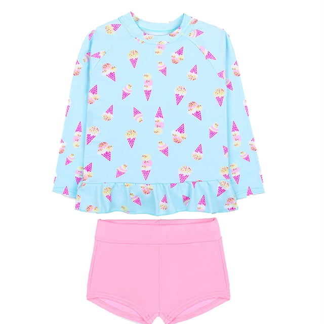 MIASHUI Girls Swimsuits 2 Piece Rash Guard Sets in blue for ages 5-6 years. The set includes a long-sleeve rash guard top with a ruffled hem and an ice cream cone print, paired with solid pink ruffle shorts. Made from lightweight, breathable polyester, this swimwear is ideal for beach outings, swimming classes, or water activities. Designed for comfort and ease of movement.