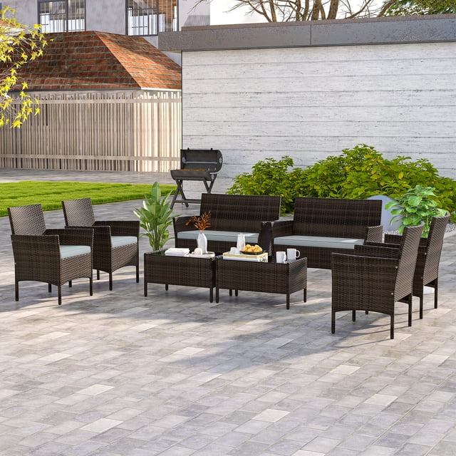 Costway 8 PCS Patio Furniture Set with mix brown PE rattan, grey washable cushions, and tempered glass coffee table. Includes loveseat, armless chairs, and coffee tables, ideal for outdoor patio dining or lounging. Set displayed on a spacious patio with greenery in the background.