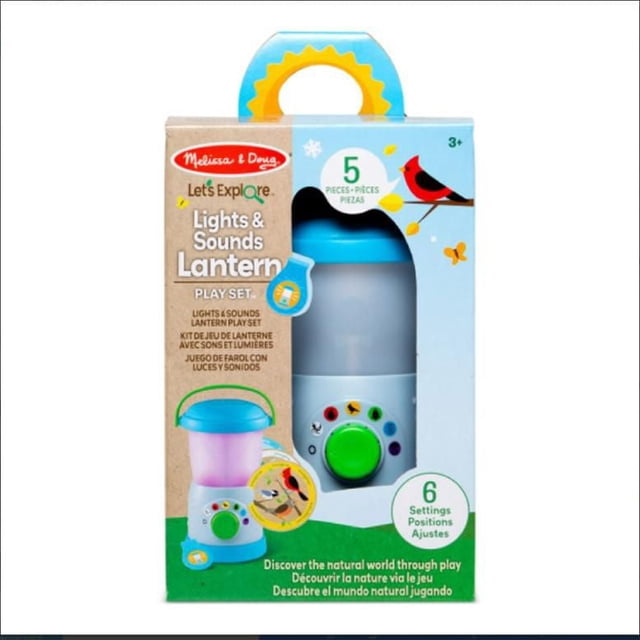 Let’s Explore Light & Sound Camping Lantern Play Set in packaging showing a blue and white lantern with a green dial for six colored light and nature sound settings, including birds and campfire sounds, designed for educational and imaginative play for children aged 3 and up.