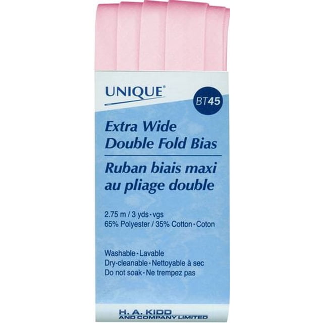 UNIQUE Extra Wide Double Fold Bias Tape, 16 mm x 2.75 m (5/8 in x 3 yd), light pink poly-cotton tape pre-folded on the bias for smooth edge binding in sewing projects, shown folded with packaging label listing fabric blend and care instructions, suitable for garment and home décor edges.